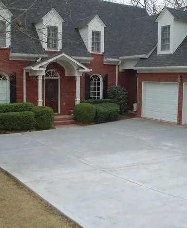 Elegant brick house with manicured lawn and driveway