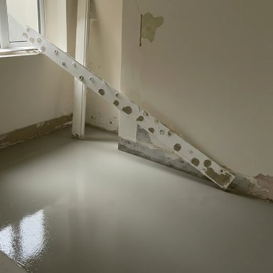 Newly poured floor with construction tools, gray finish