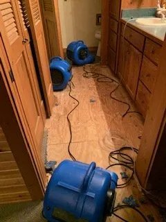 Blue air movers in a flooded bathroom