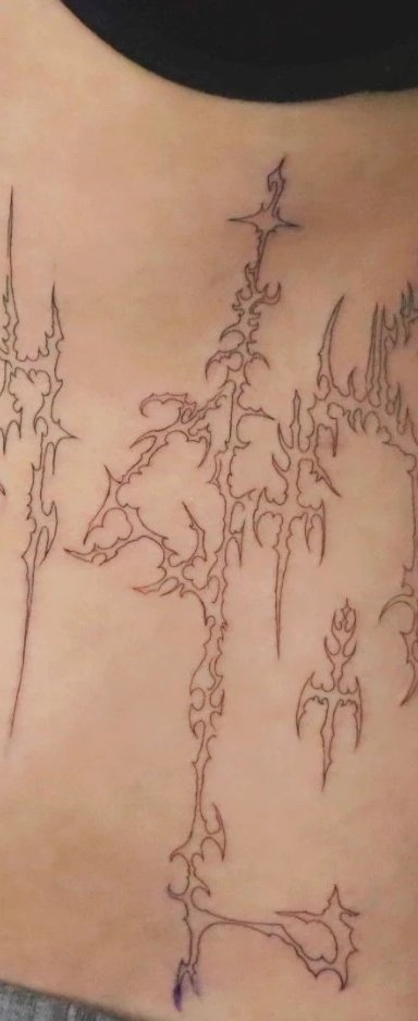 Abstract tattoo design on a person's abdomen