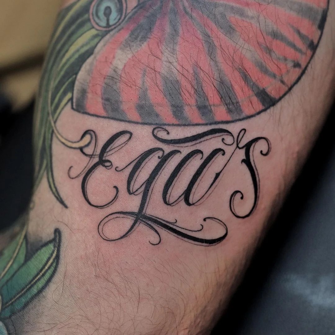 Tattoo design featuring the word 'equus' and decorative elements