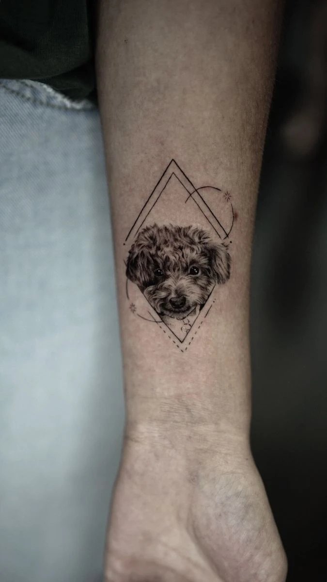 Detailed tattoo of a dog's face within geometric patterns
