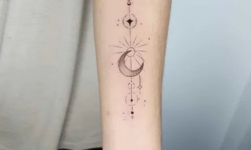 Black and grey moon tattoo on arm