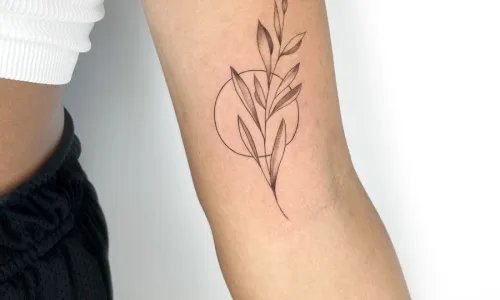 Elegant botanical tattoo design on arm