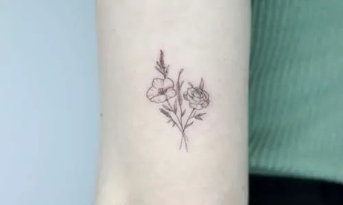 Delicate floral tattoo on a person's arm
