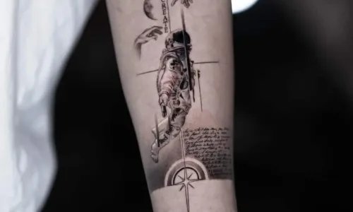 Detailed tattoo of an astronaut on a forearm