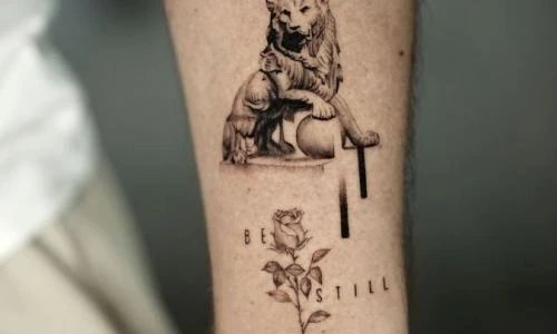 Tattoo of a lion with a cub and a rose on a forearm