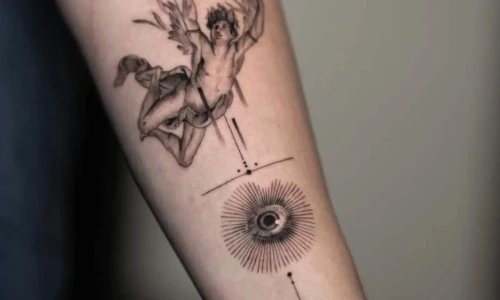 Tattoo artwork featuring an angel and an eye on the arm.