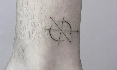 Minimalistic tattoo design featuring circular pattern and arrows.