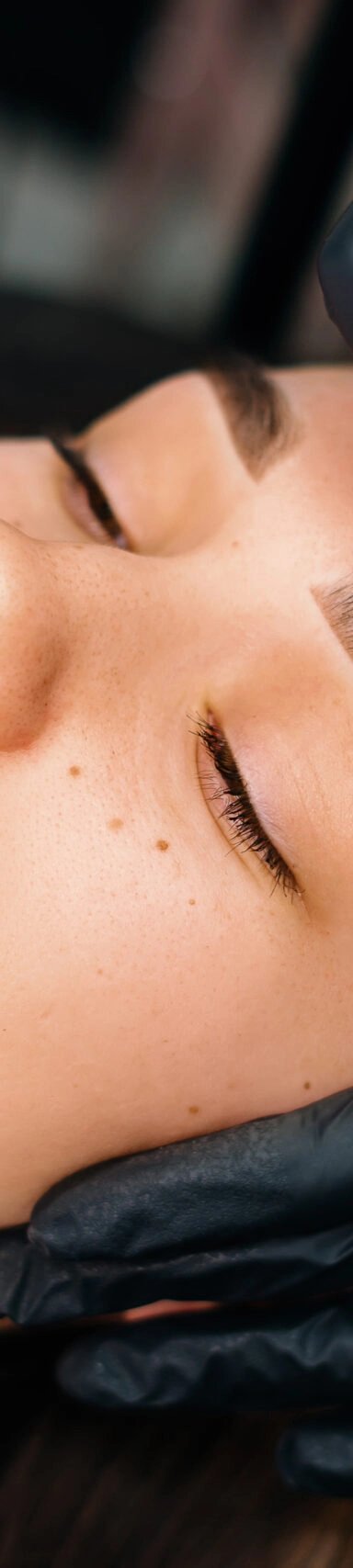 Woman receiving eyebrow microblading treatment