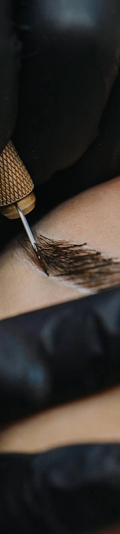 Beauty professional performing microblading on a client.