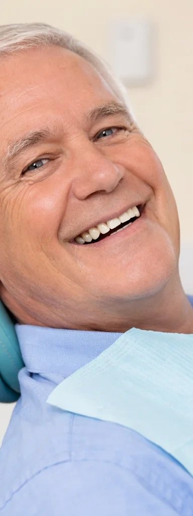 Smiling elderly man in dentist chair