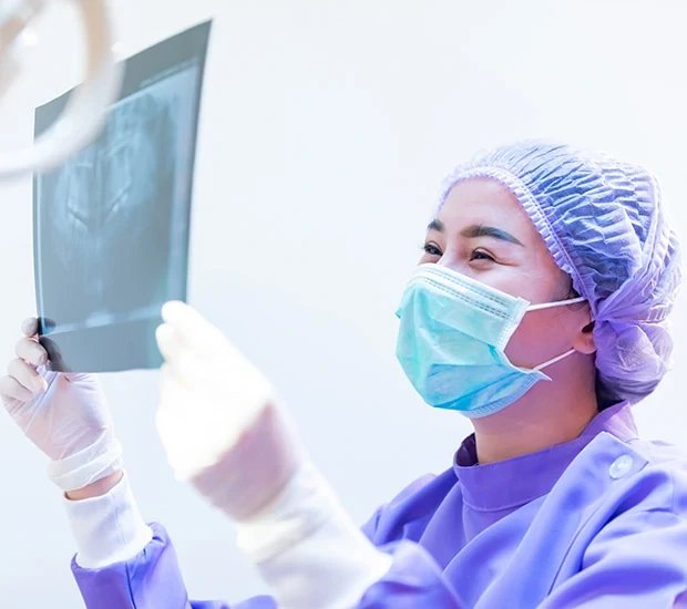 Medical professional analyzing X-ray image