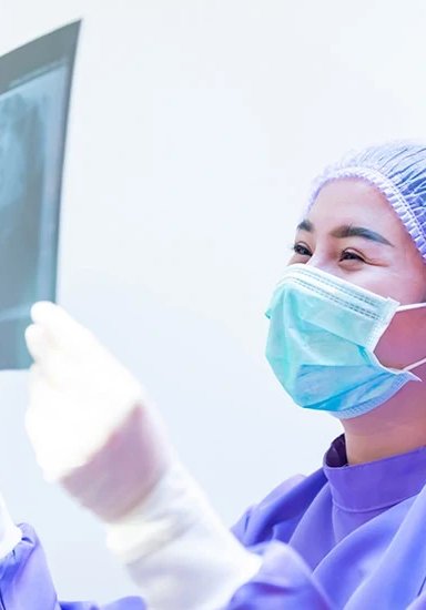 Medical professional analyzing X-ray image