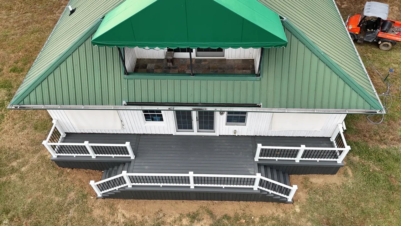 Aerial view of a green-roofed house with a deck
