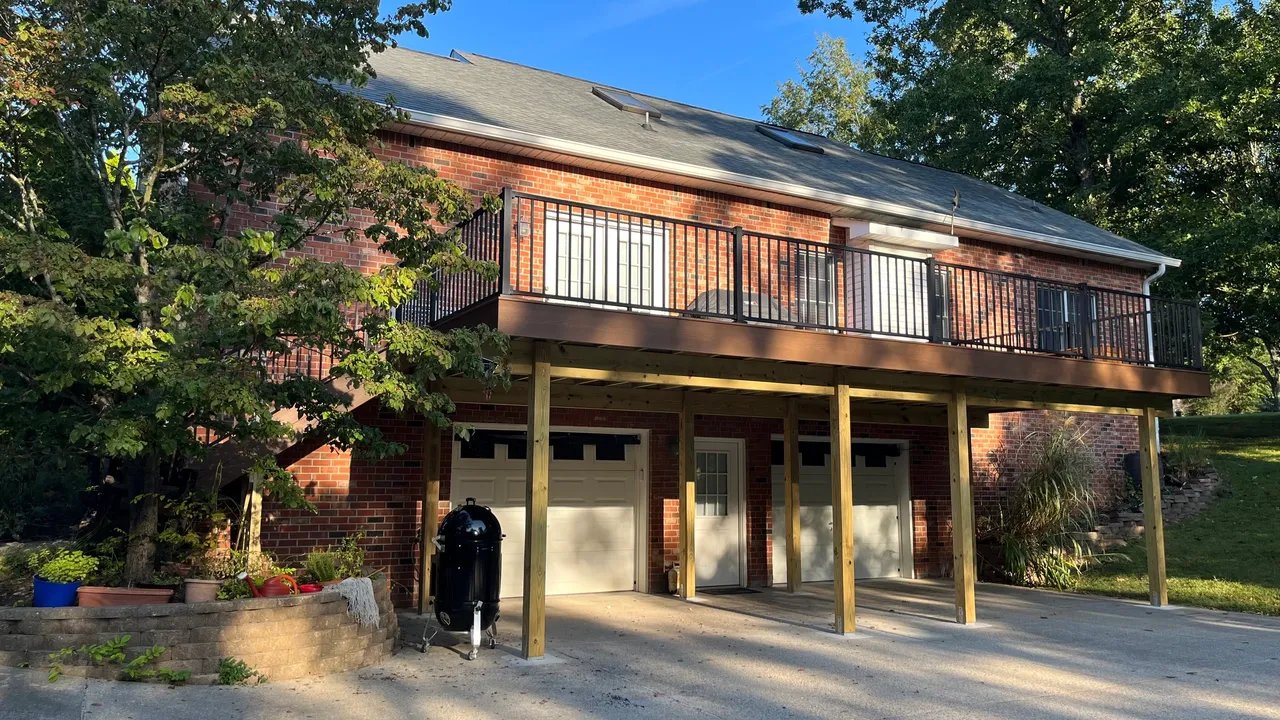 Modern two-story brick house with balcony and garage