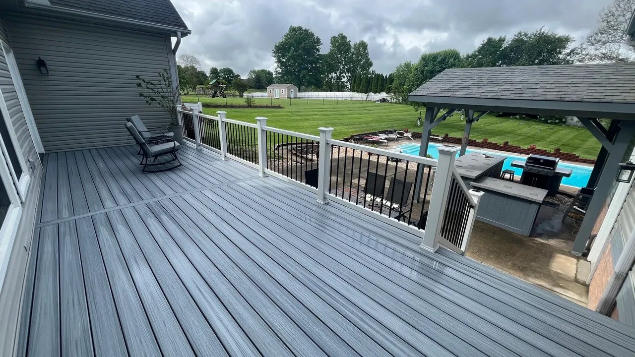 Inviting deck view with pool and backyard greenery