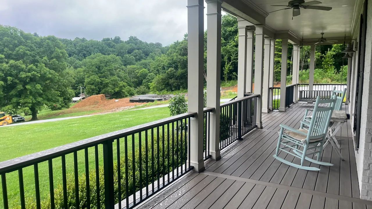 Scenic view from porch with rocking chairs and lush greenery