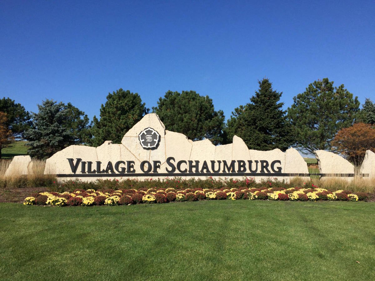 Schaumburg village sign surrounded by flowers