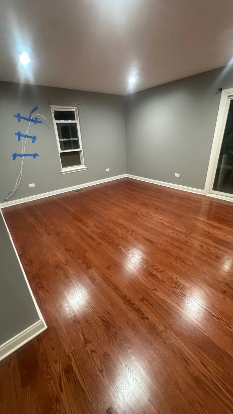 Empty room with dark wooden floor and gray walls