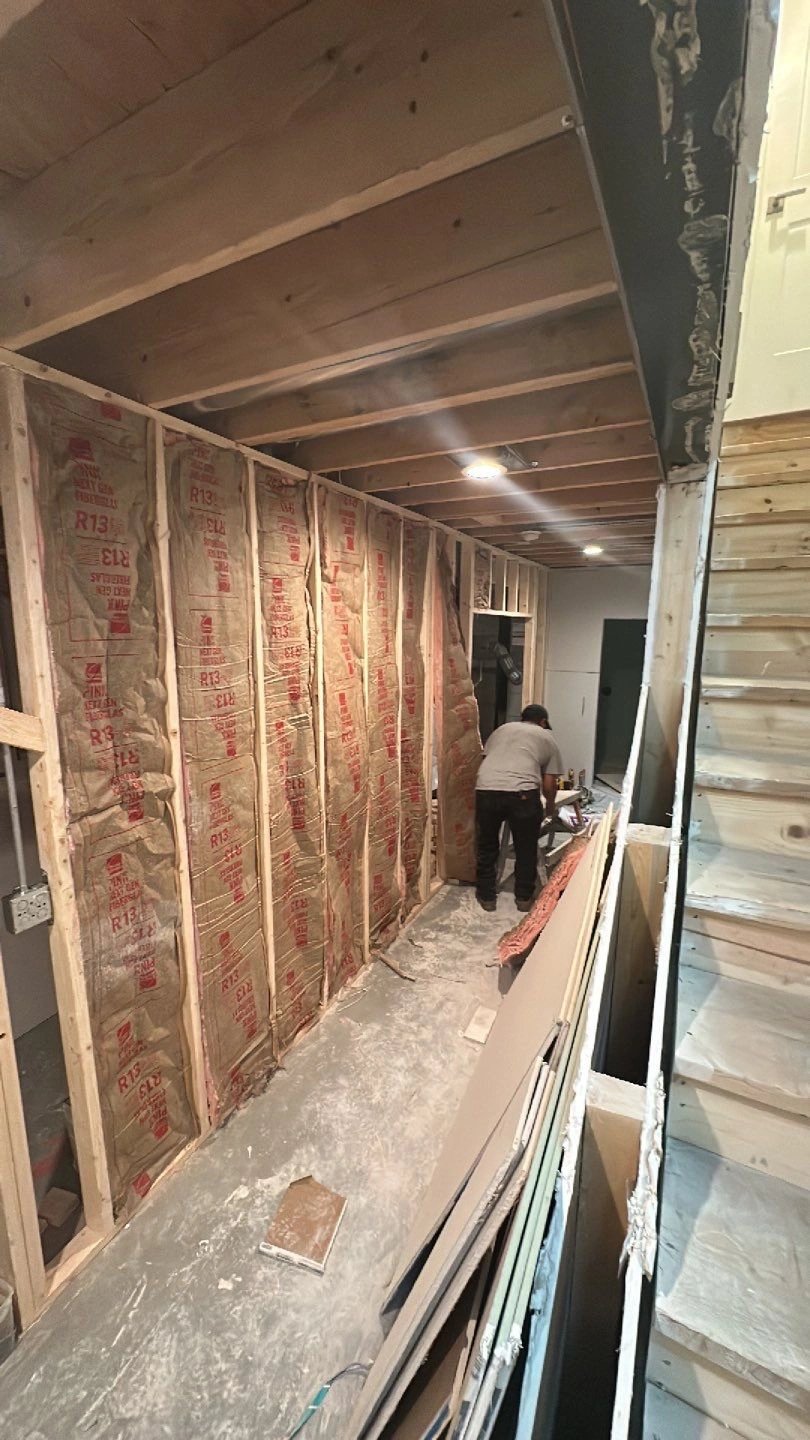 Construction worker insulating a wall in a home renovation