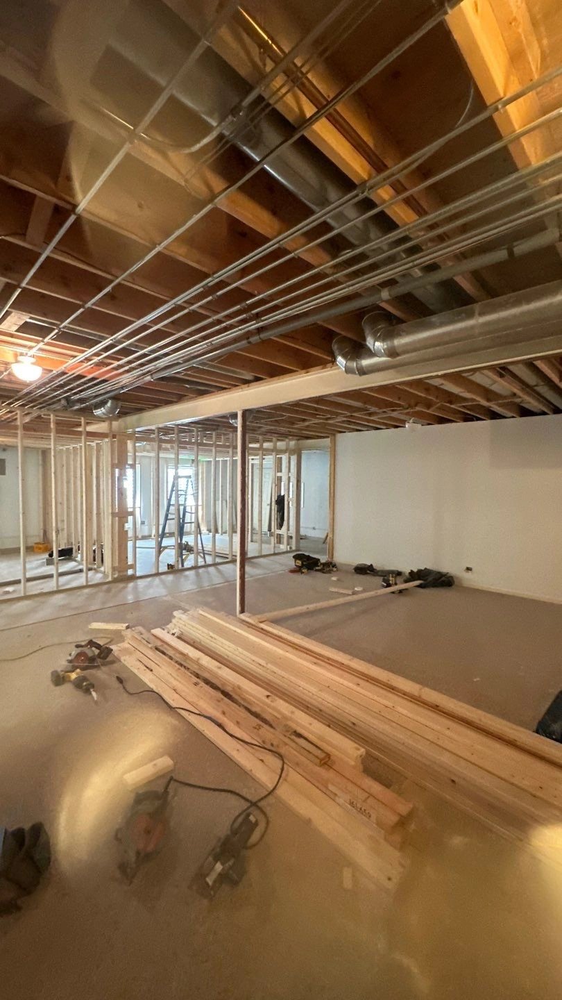 Interior construction site showing framed walls and tools
