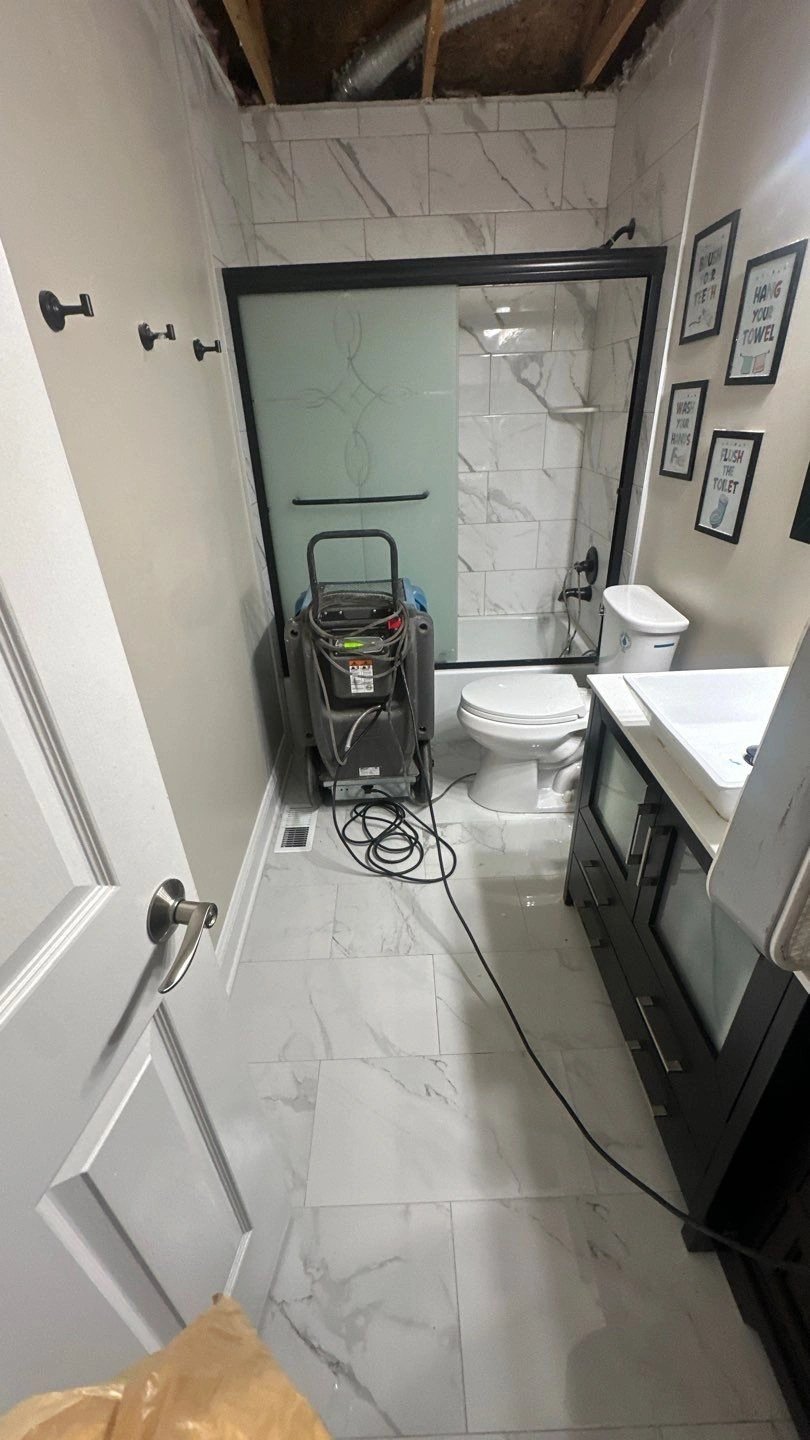 Bathroom renovation in progress with cleaning equipment