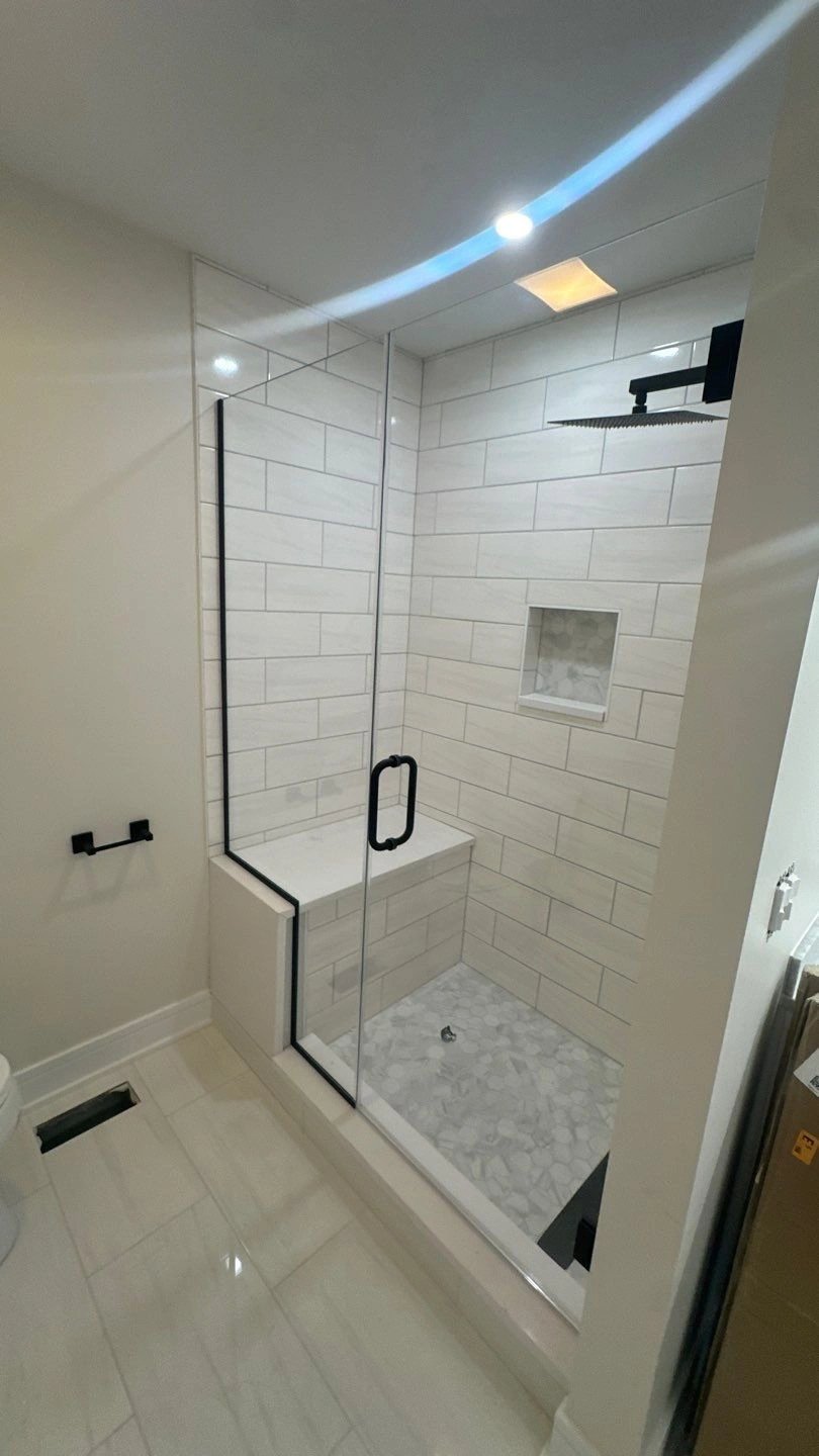 Modern bathroom featuring a glass shower and sleek tiles