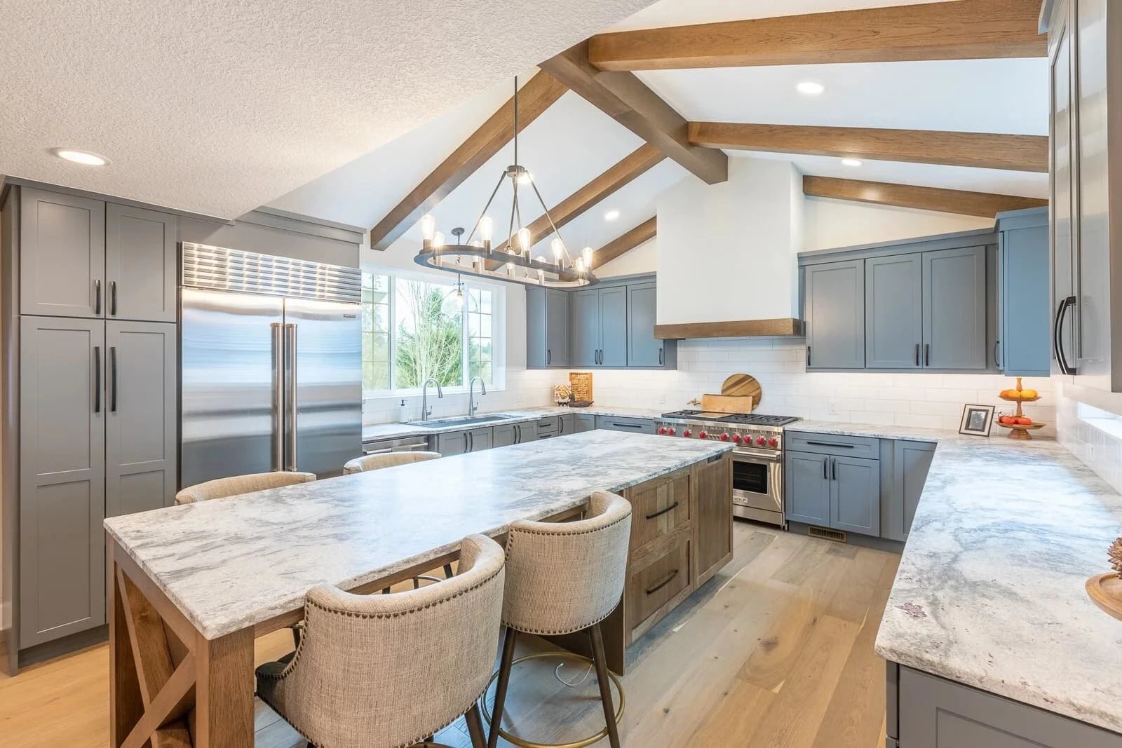Modern kitchen with wooden beams and marble island