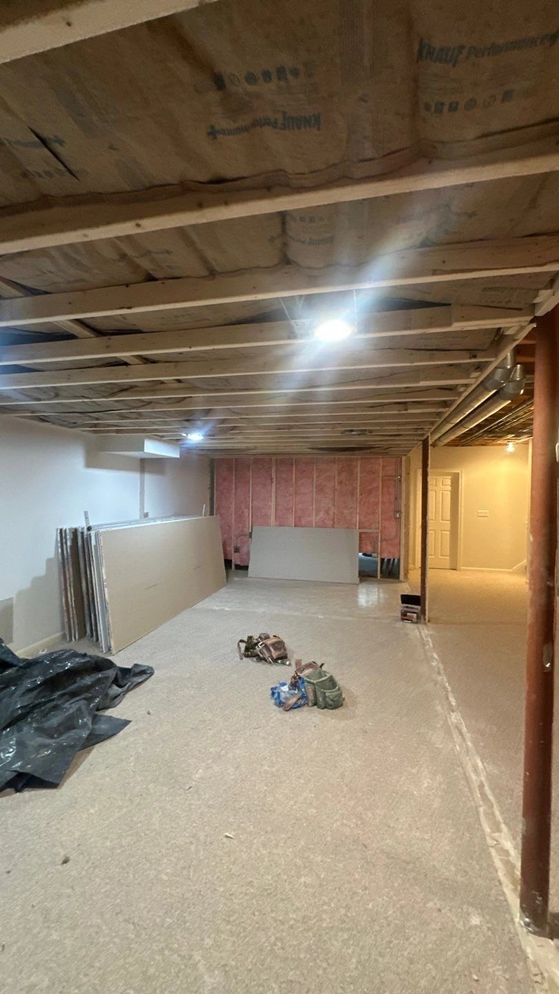 Renovated basement with construction materials and lighting