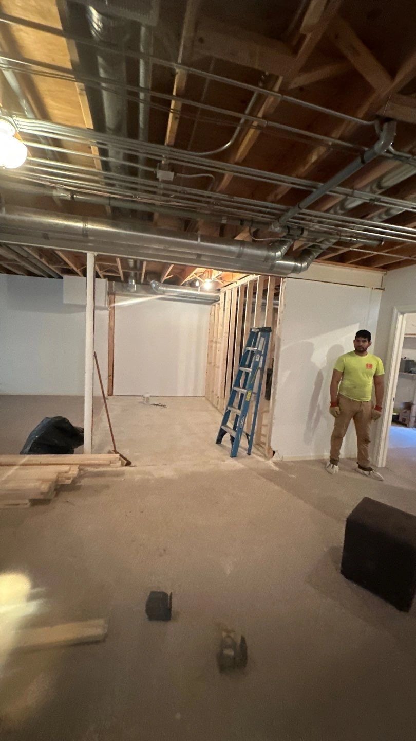 Construction site with a person supervising framing.