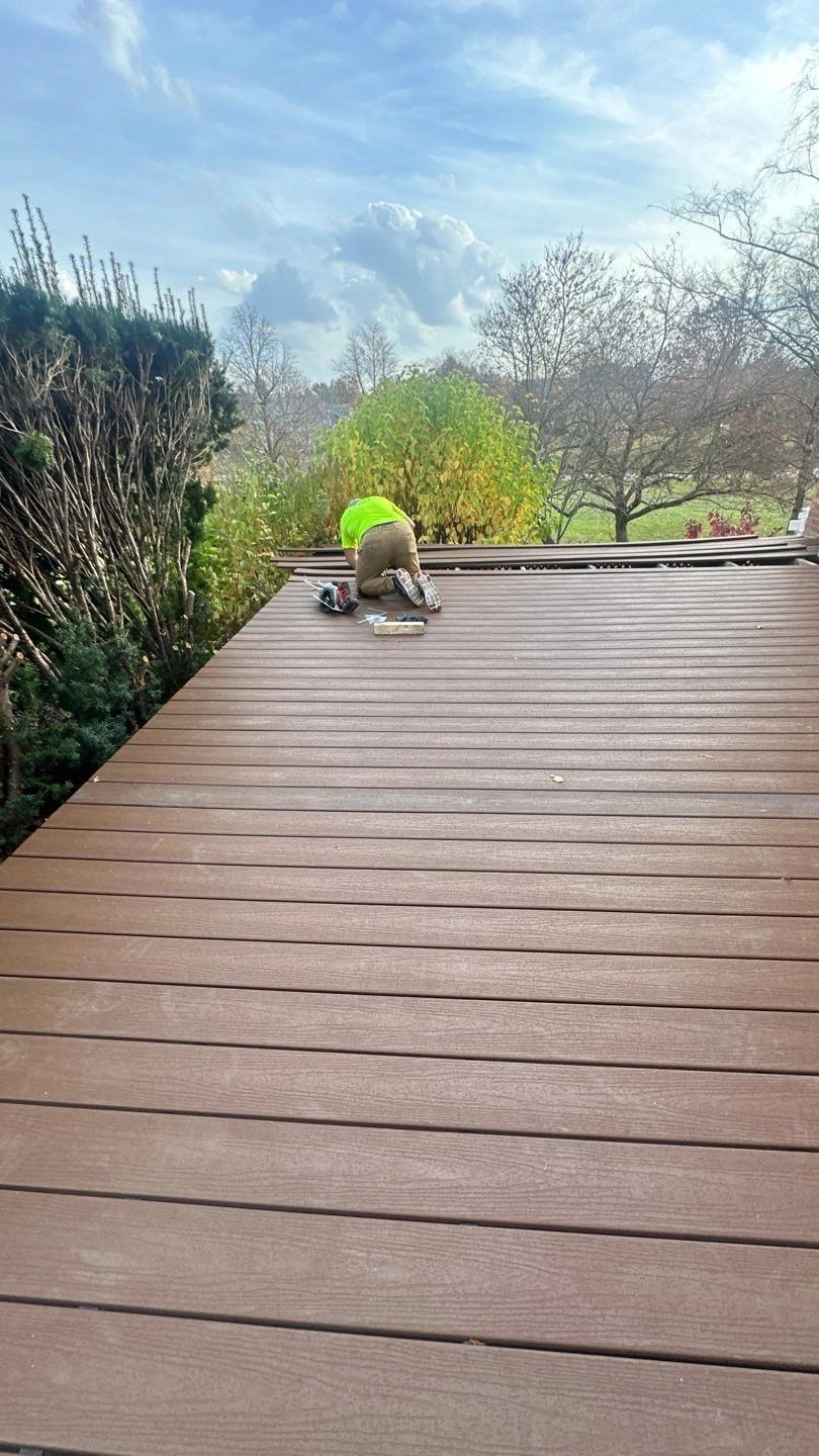 Person working on deck installation outdoors