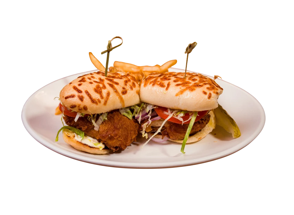 Two chicken sandwiches with crispy fried chicken and toppings