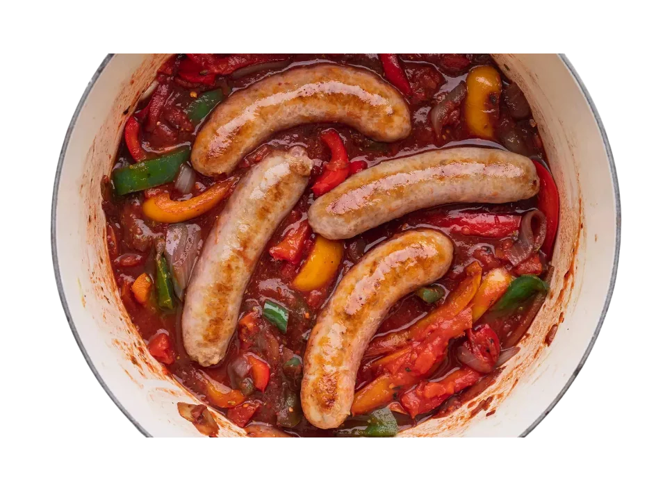 Cooked sausages with peppers in a pot