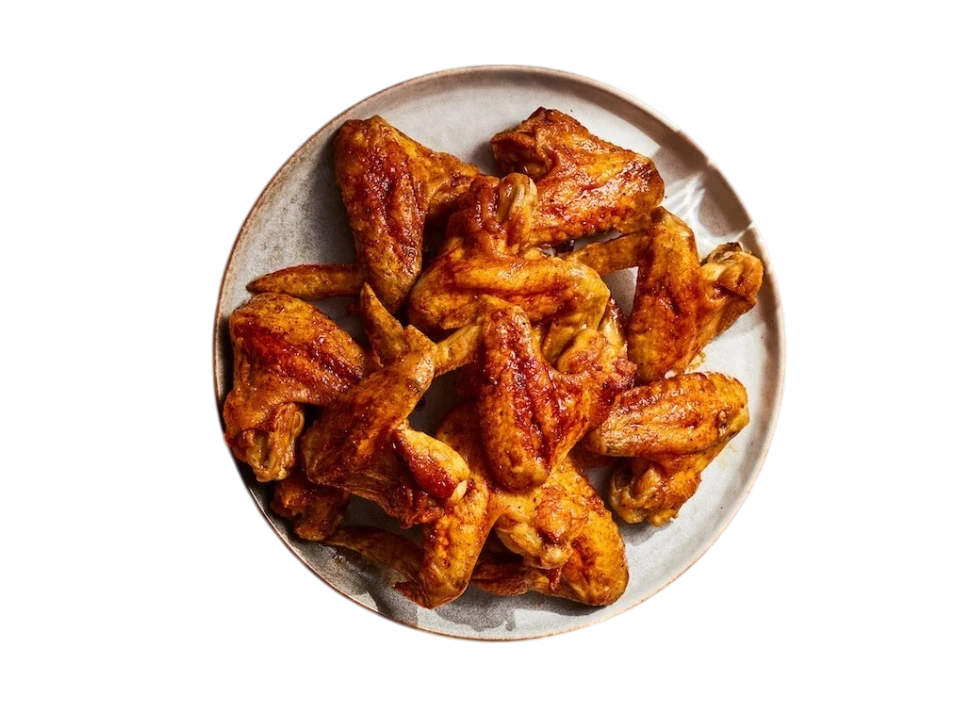 A generous serving of golden-brown chicken wings on a round plate.