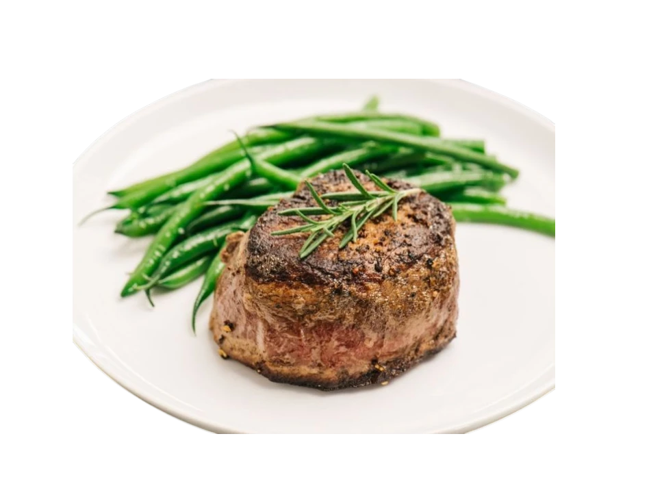 Delicious steak with green beans on a white plate