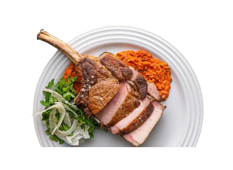 Deliciously cooked roast meat served with sauce and greens.