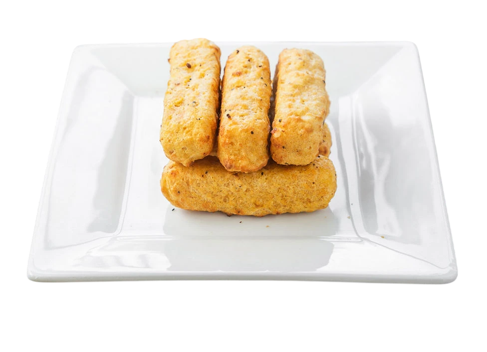 Plate of golden-brown veggie sticks stacked on a white plate