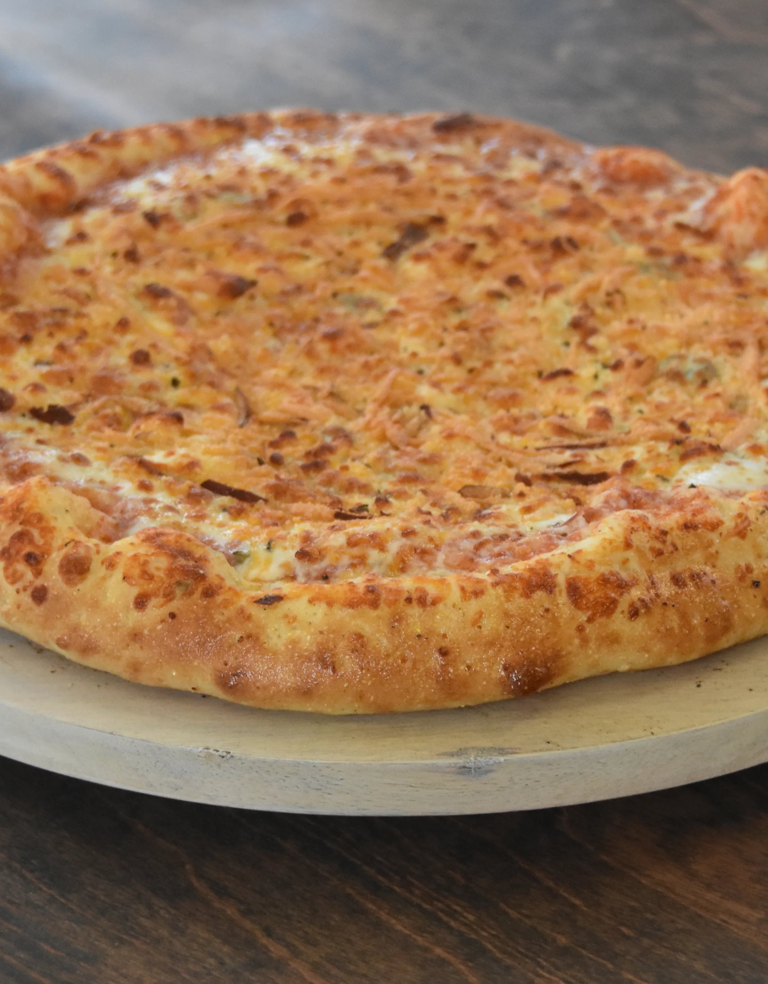 Delicious cheese pizza on a wooden board