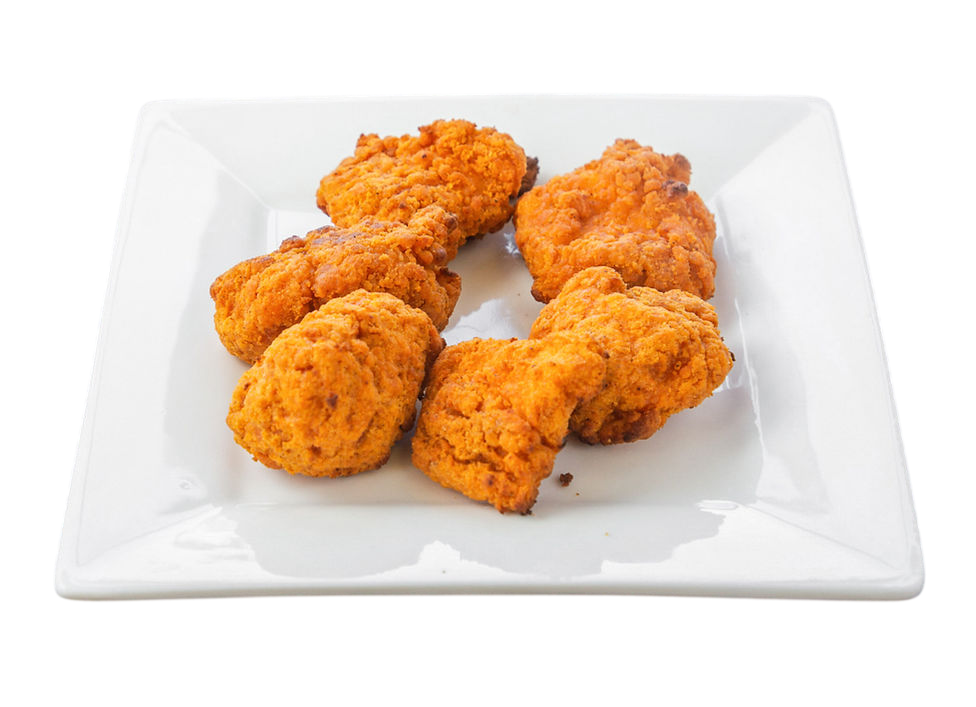 Golden fried chicken pieces on a white plate