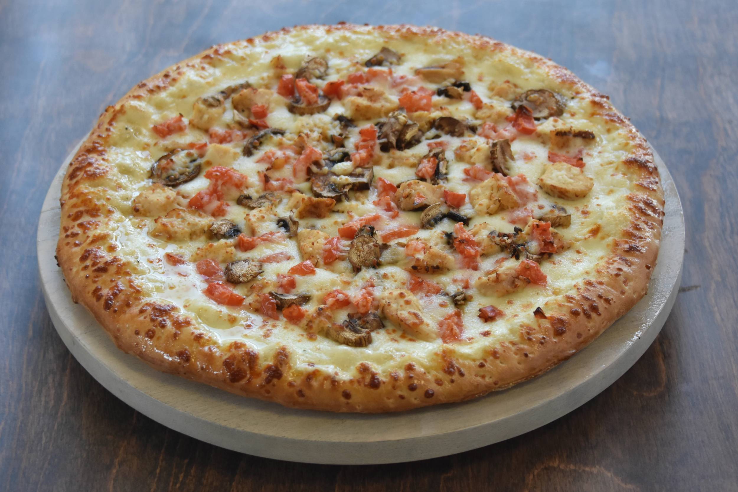 Delicious pizza with toppings on a wooden table