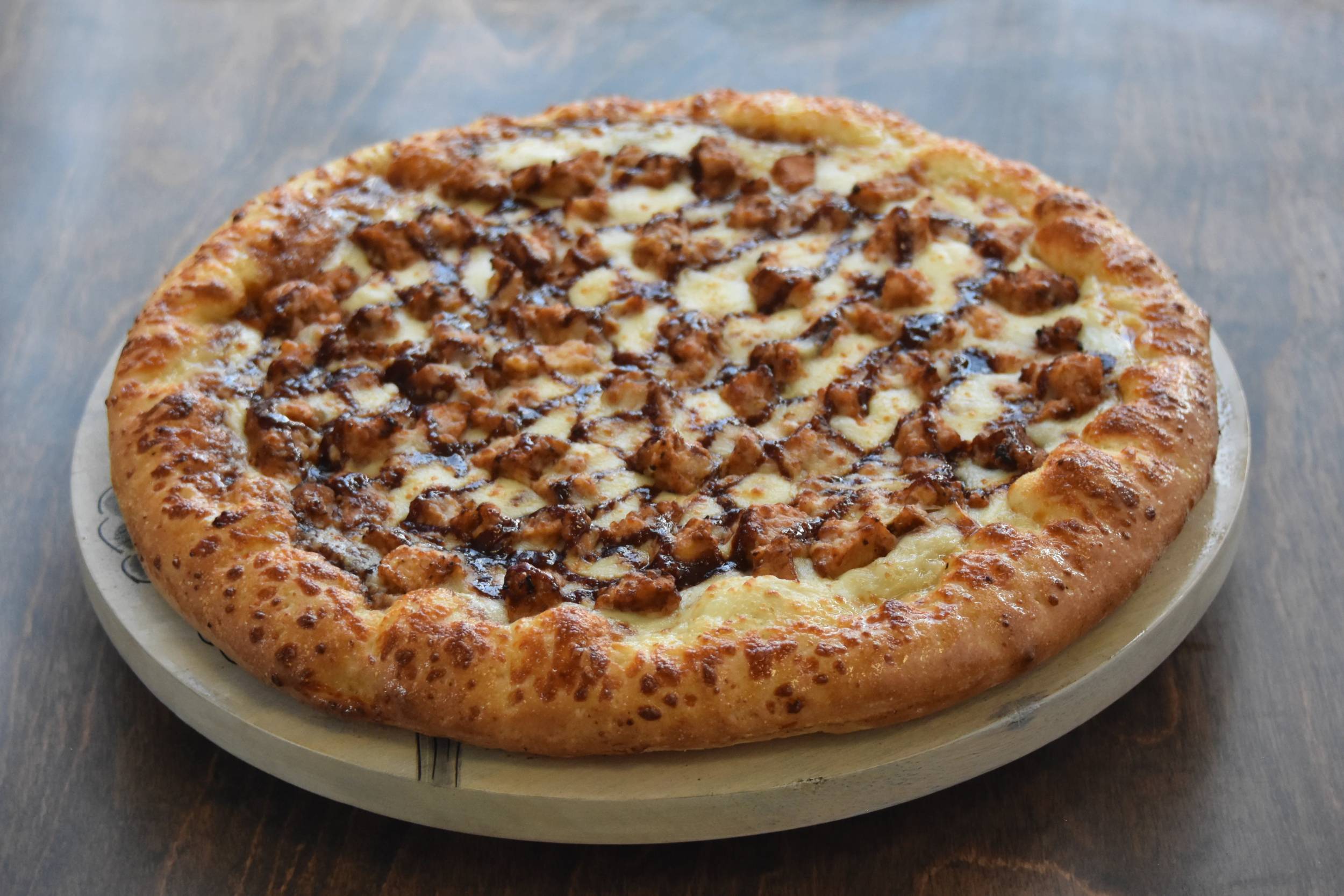 Delicious pizza topped with grilled chicken pieces