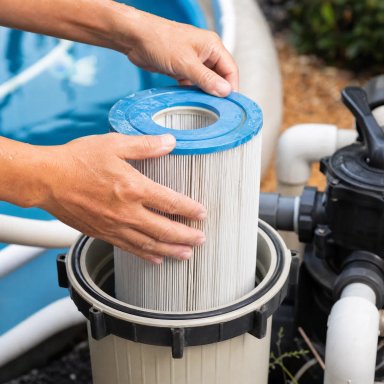 Person replacing a pool filter cartridge.