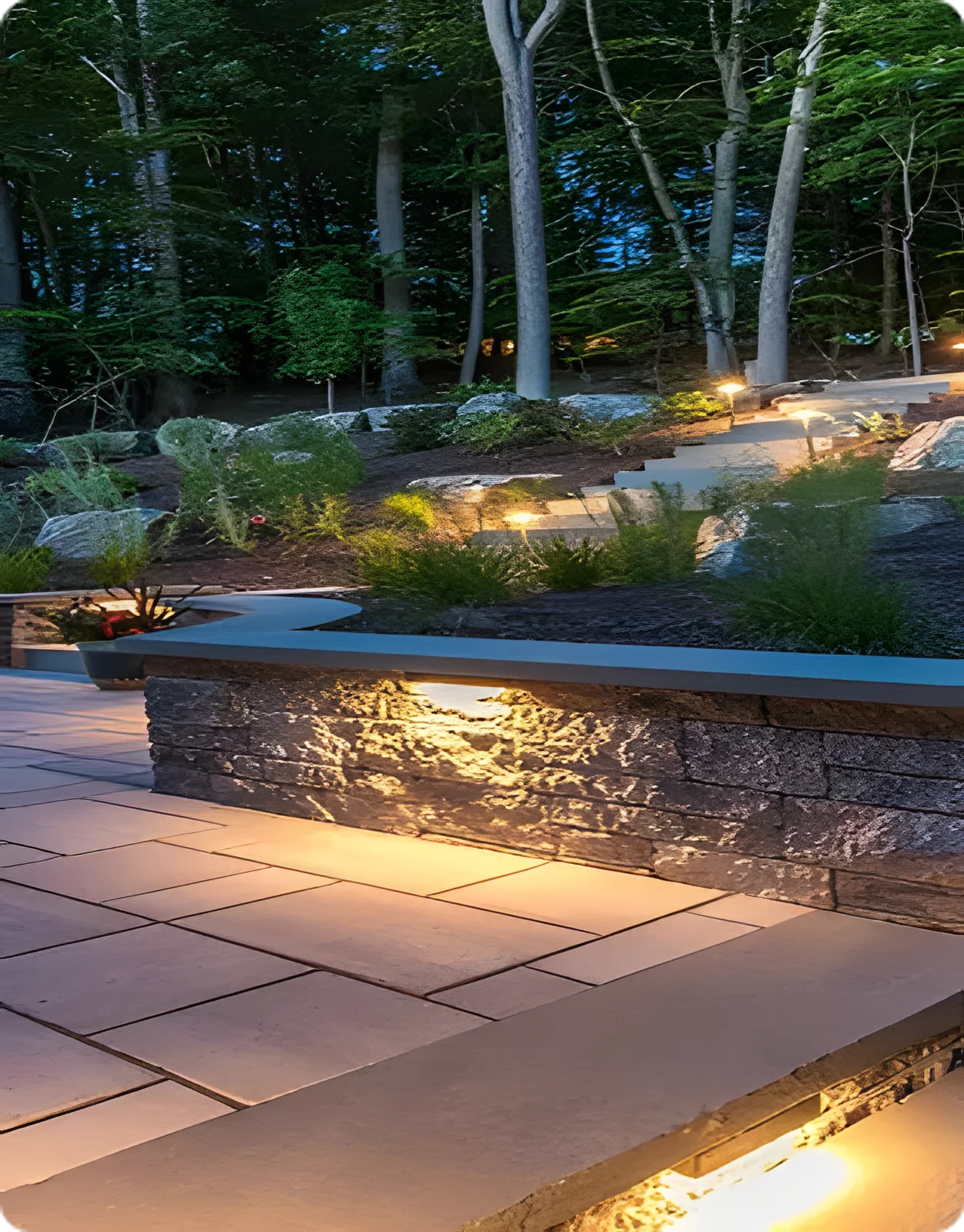 Beautifully landscaped outdoor space at dusk with lighting