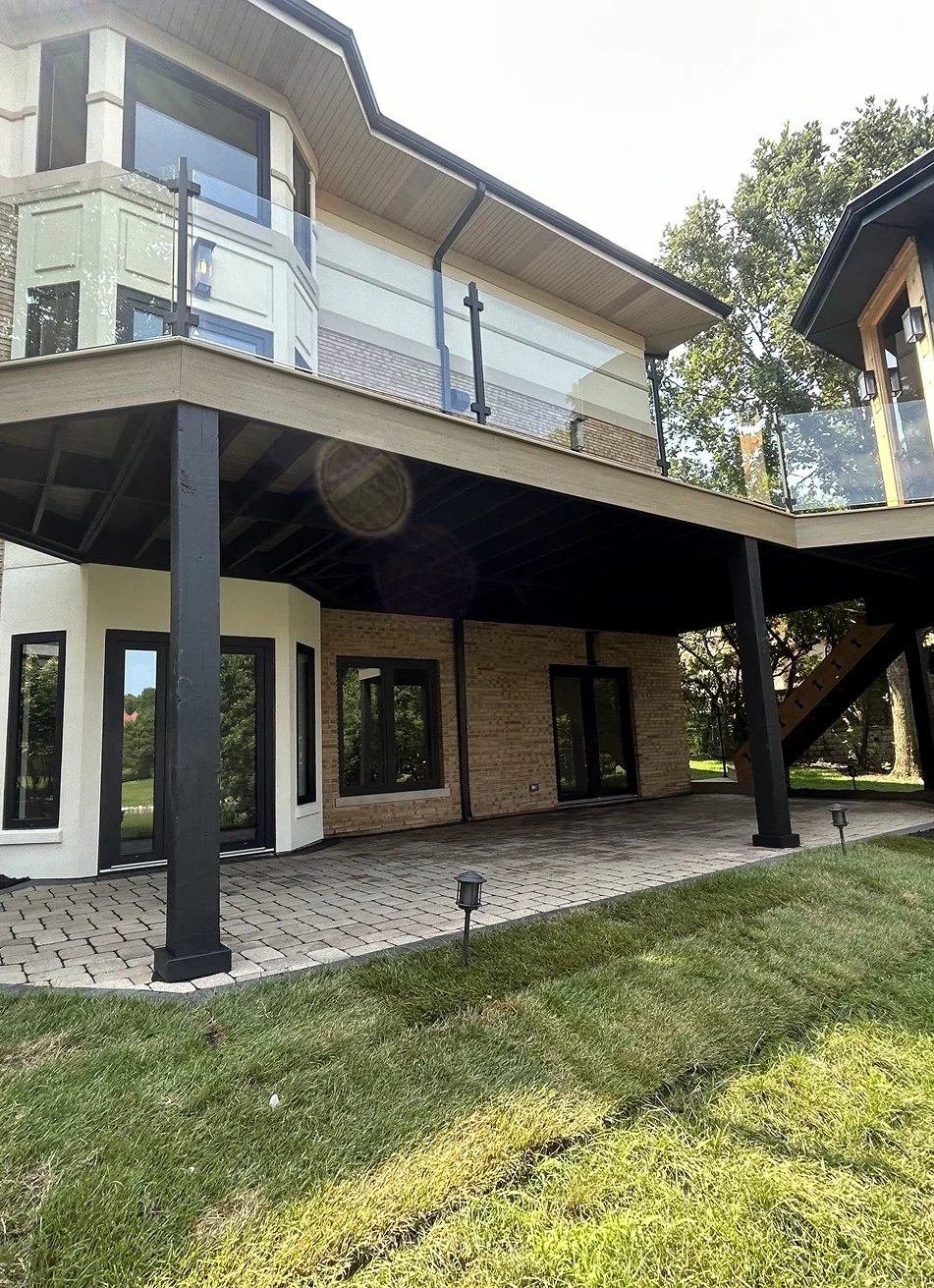 Modern house exterior with balcony and patio