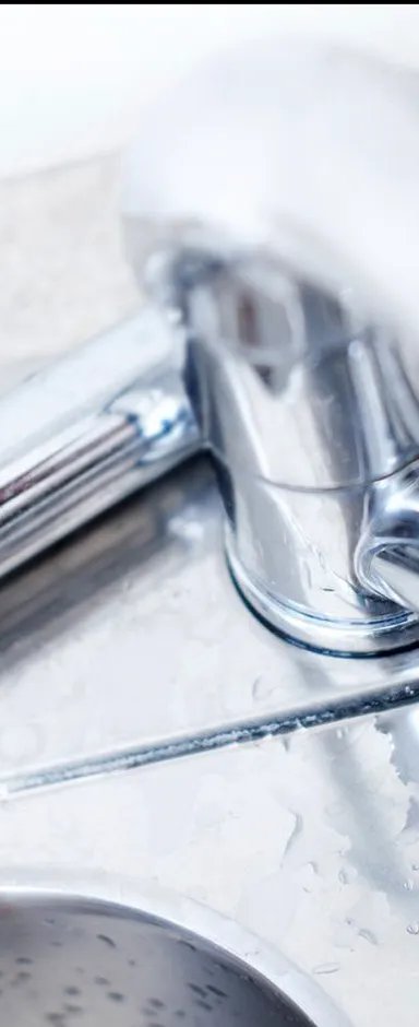 Close-up of a shiny chrome kitchen faucet with sprayer