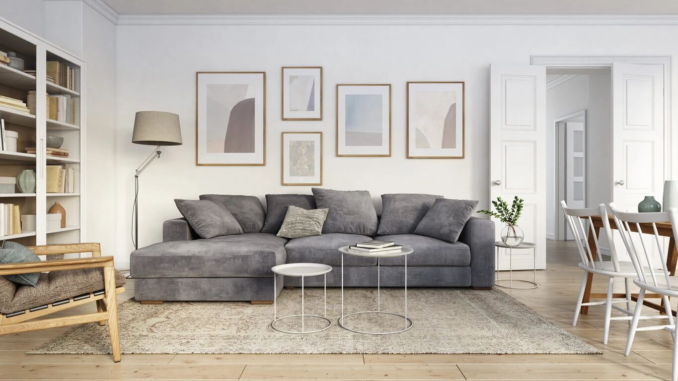 Modern living room with gray sectional sofa and artwork
