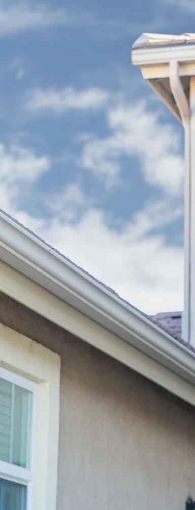 Home exterior with roof edge and blue sky