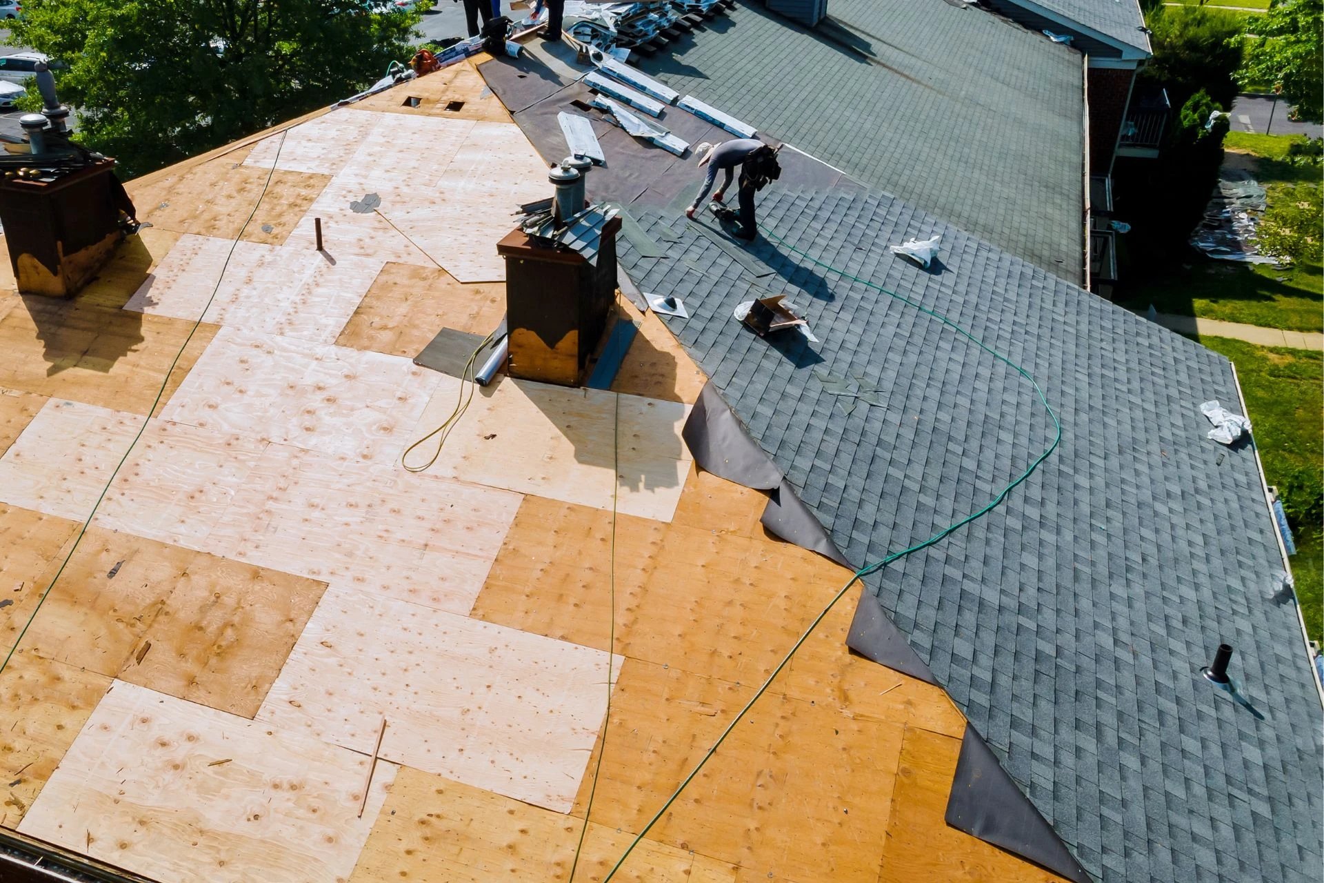 Roofing installation and repair underway on a house