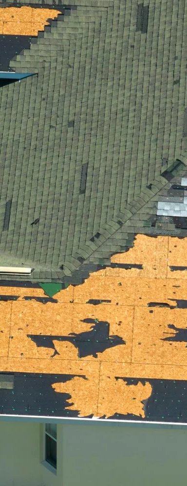 Roofing installation with shingles and underlayment showing progress
